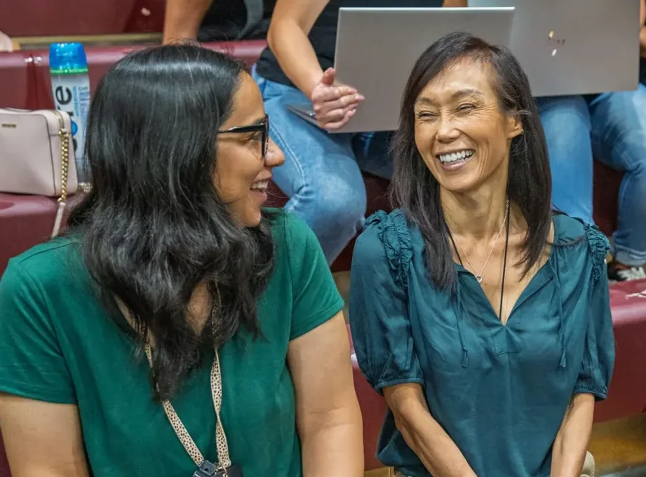 Two educators laughing together during an UNLOCK session
